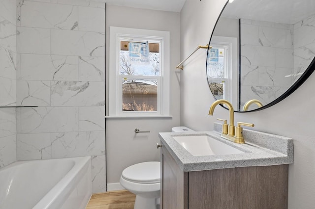 full bathroom with toilet, vanity, and tiled shower / bath combo