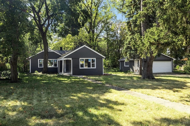 single story home featuring an outbuilding, a front yard, and a garage