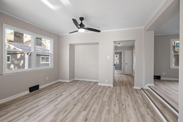 spare room featuring light wood-type flooring, ceiling fan, and crown molding