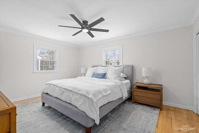 bedroom featuring ceiling fan, ornamental molding, and hardwood / wood-style flooring