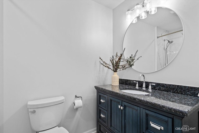 bathroom with toilet, a shower, and vanity