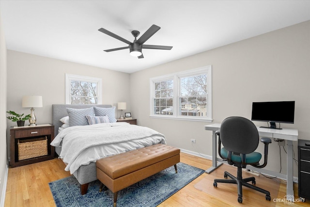 bedroom with multiple windows, light wood-type flooring, and ceiling fan