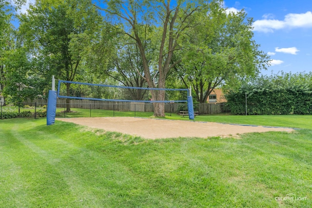 view of community featuring volleyball court and a yard