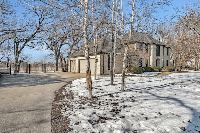 snow covered property featuring a garage