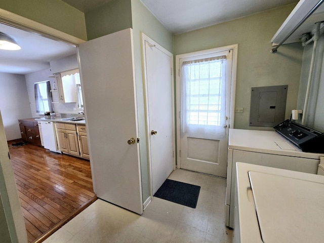 washroom with light floors, laundry area, electric panel, a sink, and independent washer and dryer