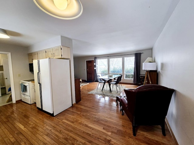 kitchen with baseboards, white appliances, and dark wood-style floors