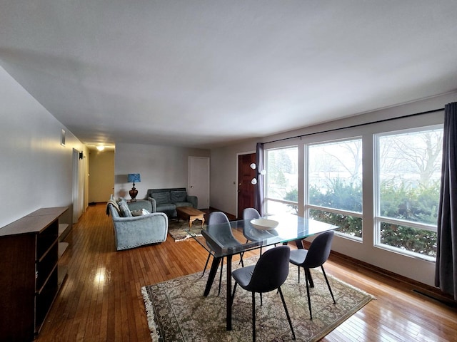 dining room with a wealth of natural light and wood-type flooring