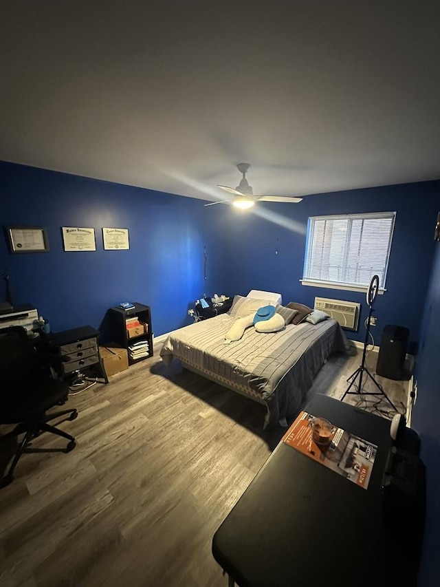 931 W Arquilla Dr Unit 316, Glenwood, IL 60425 - bedroom with a wall unit AC, wood finished floors, a desk, and a ceiling fan