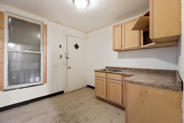 kitchen with light brown cabinetry and sink