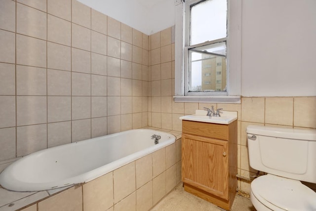 bathroom with toilet, tile walls, a relaxing tiled tub, and vanity