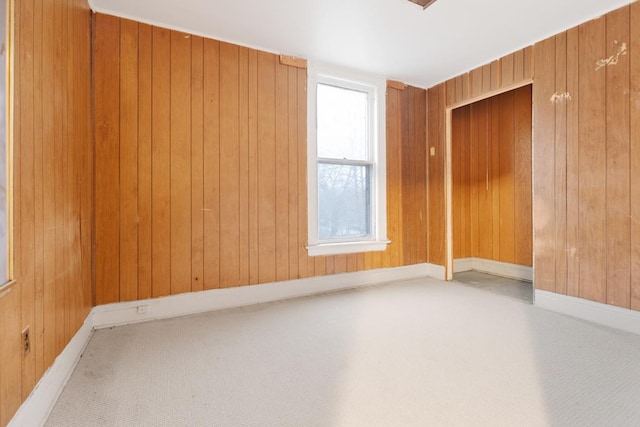 empty room featuring wooden walls