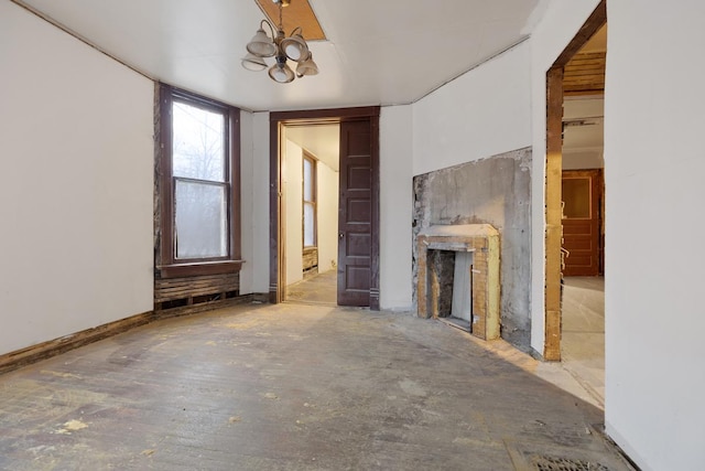 unfurnished living room with a chandelier