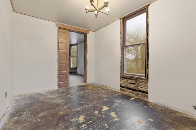 unfurnished room featuring a notable chandelier