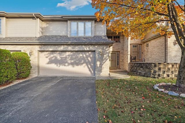 view of front facade with a front yard and a garage