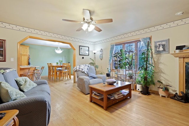 living room with light wood-type flooring and ceiling fan