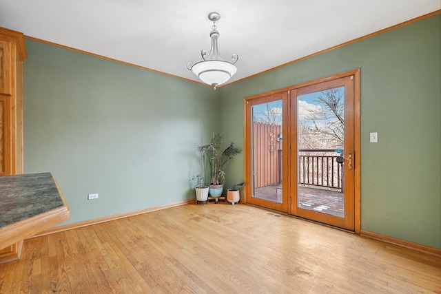 interior space featuring crown molding and light hardwood / wood-style floors