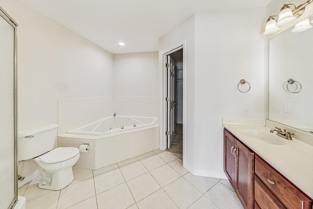 bathroom featuring toilet, vanity, tile patterned floors, baseboard heating, and a relaxing tiled tub