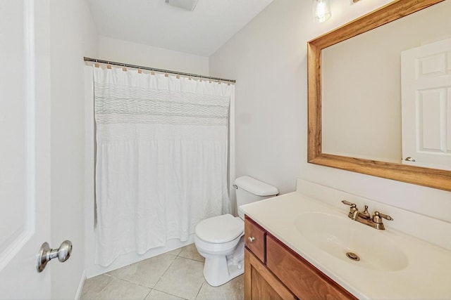 bathroom featuring toilet, vanity, and tile patterned flooring