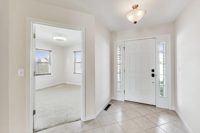 foyer entrance with light colored carpet