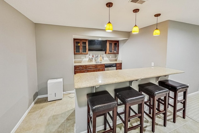 kitchen with hanging light fixtures, a breakfast bar, and stainless steel dishwasher