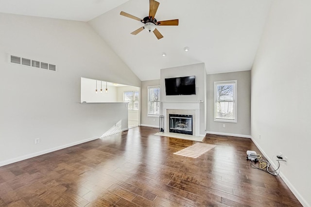 unfurnished living room with high vaulted ceiling, hardwood / wood-style floors, and ceiling fan