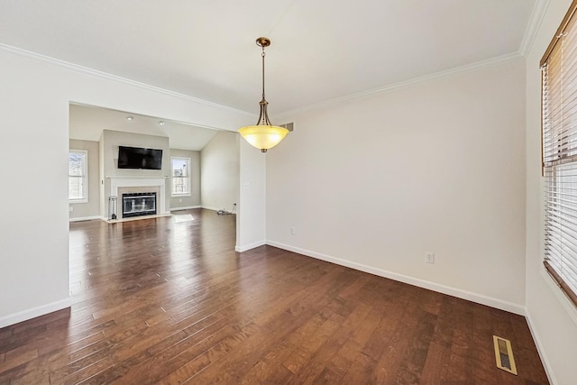 unfurnished living room featuring dark wood-type flooring, ornamental molding, and lofted ceiling