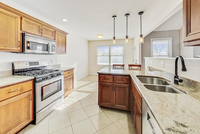 kitchen with sink, hanging light fixtures, appliances with stainless steel finishes, and plenty of natural light