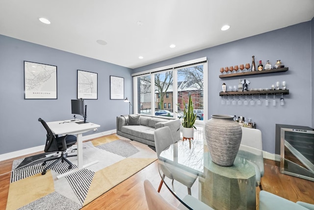 office space with bar area and hardwood / wood-style floors