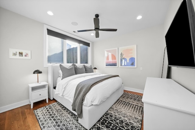 bedroom featuring ceiling fan and dark hardwood / wood-style floors