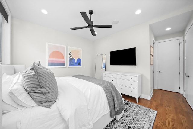 bedroom with ceiling fan and dark hardwood / wood-style flooring