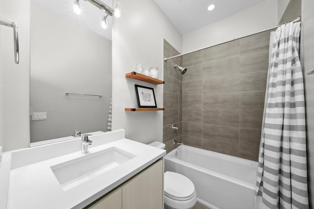 full bathroom featuring toilet, shower / bathtub combination with curtain, and vanity