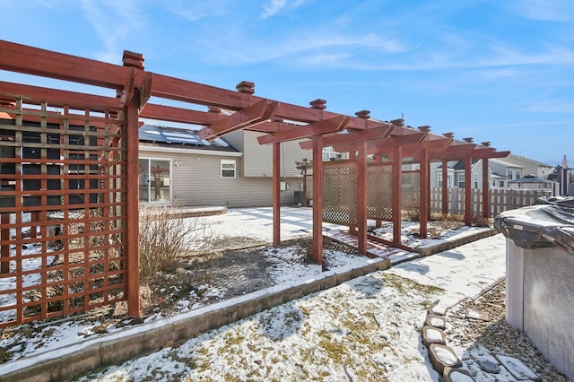 snow covered patio with a pergola