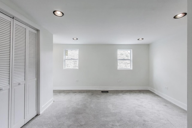 unfurnished bedroom featuring baseboards, recessed lighting, and carpet