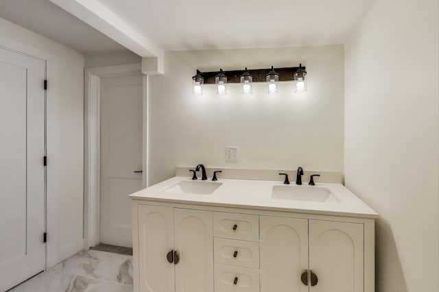 full bathroom featuring marble finish floor and a sink