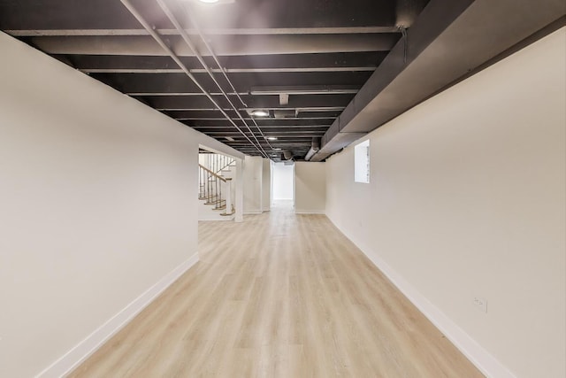 hall featuring stairway, wood finished floors, and baseboards