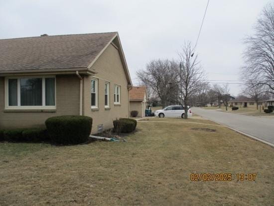 view of property exterior with a lawn