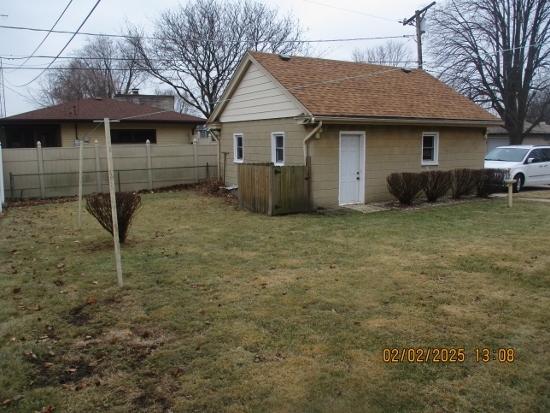 view of side of home with a lawn