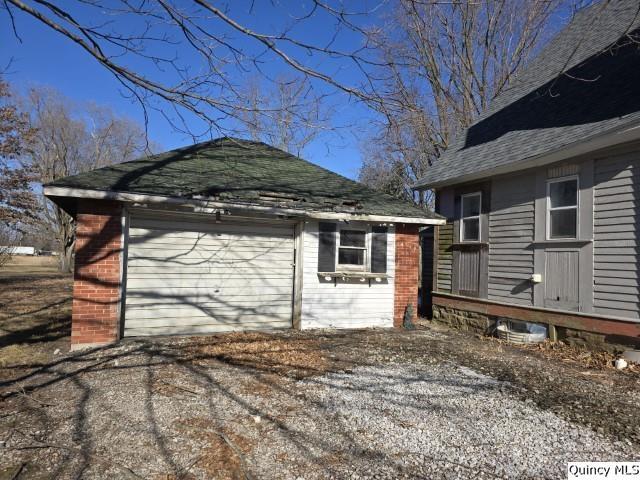 view of home's exterior featuring an outbuilding and a garage