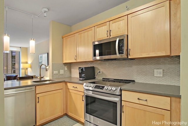 kitchen with light brown cabinetry, sink, decorative light fixtures, backsplash, and stainless steel appliances