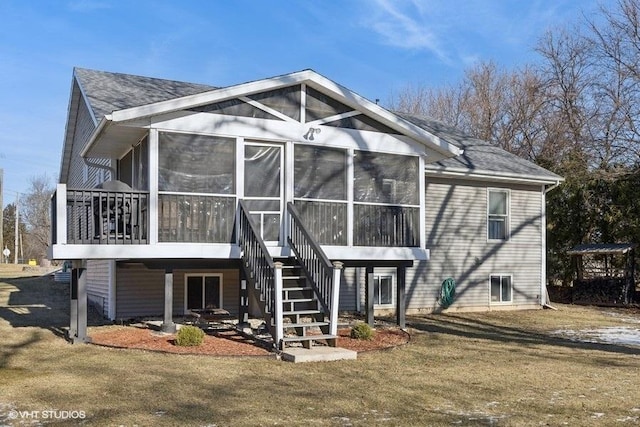 exterior space with stairway, a yard, and a sunroom