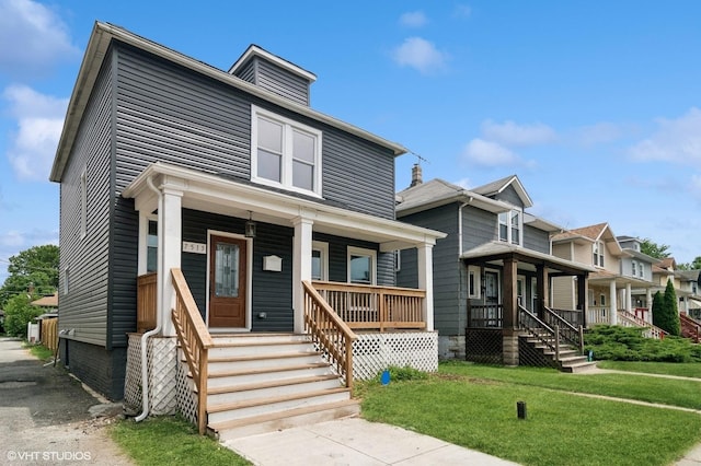 view of front of home with a front lawn and covered porch