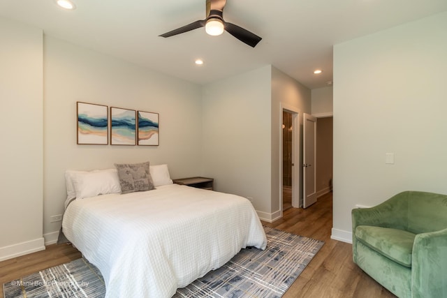 bedroom with ceiling fan and hardwood / wood-style flooring