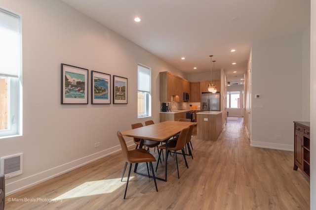 dining space with light hardwood / wood-style floors