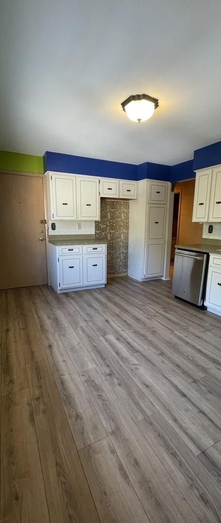 kitchen with white cabinetry, dishwasher, and light hardwood / wood-style flooring