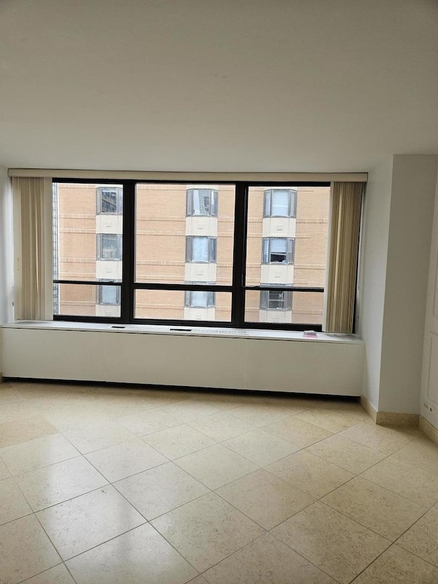 spare room featuring light tile patterned floors