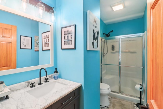 bathroom with vanity, toilet, and an enclosed shower