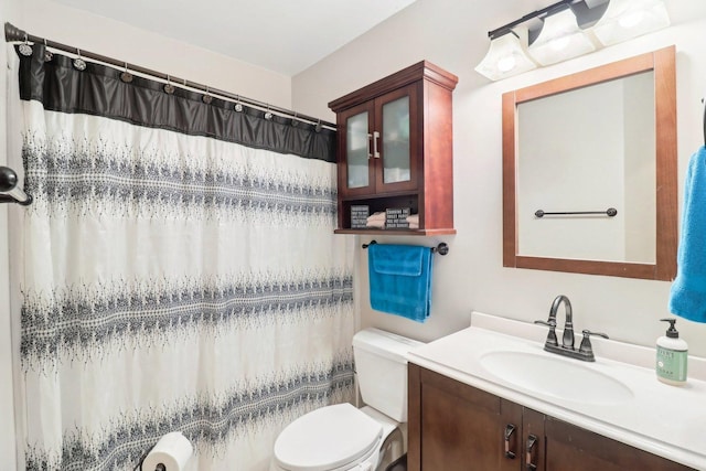 bathroom with vanity, toilet, and curtained shower