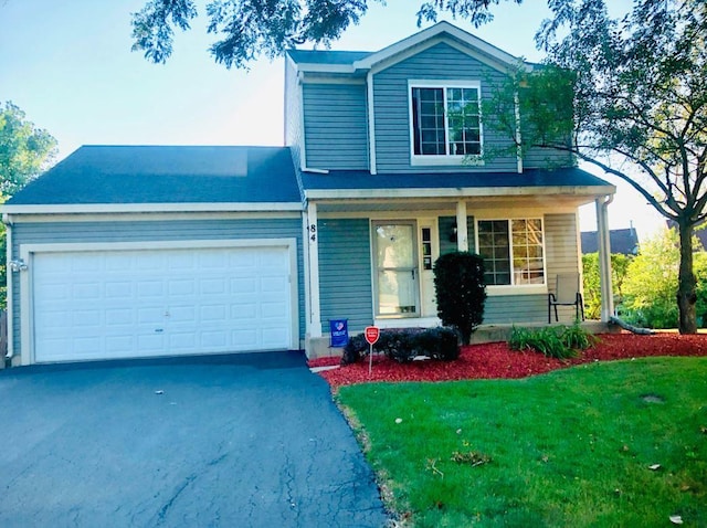 front of property with a garage and a front lawn