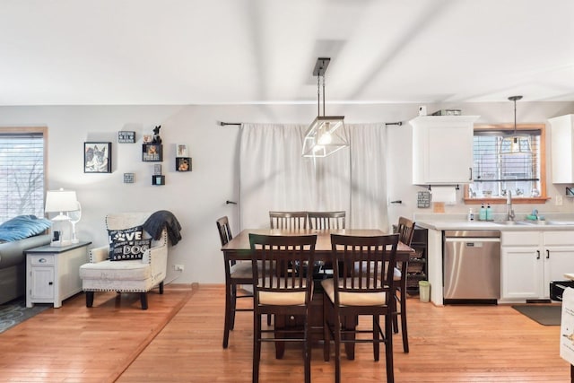 dining space featuring sink and light hardwood / wood-style floors