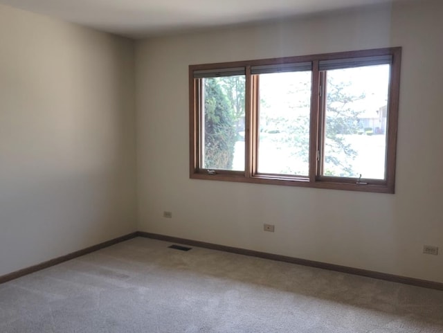 spare room with light colored carpet and plenty of natural light